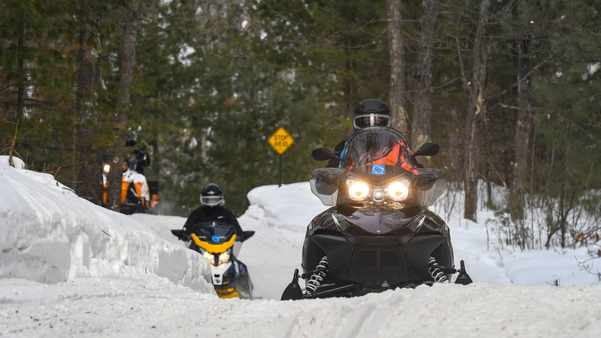 Snowmobilers riding on trails in winter Vilas County Wisconsin