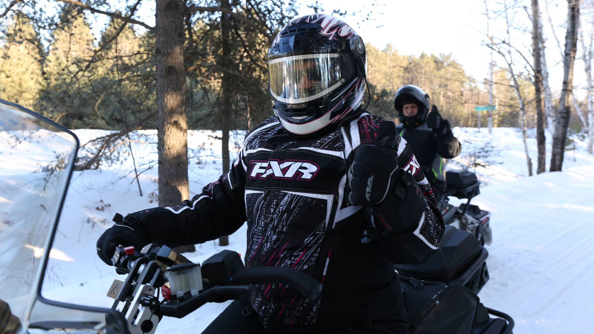 Two people on snowmobile trails near Three Lakes in Oneida County Wisconsin