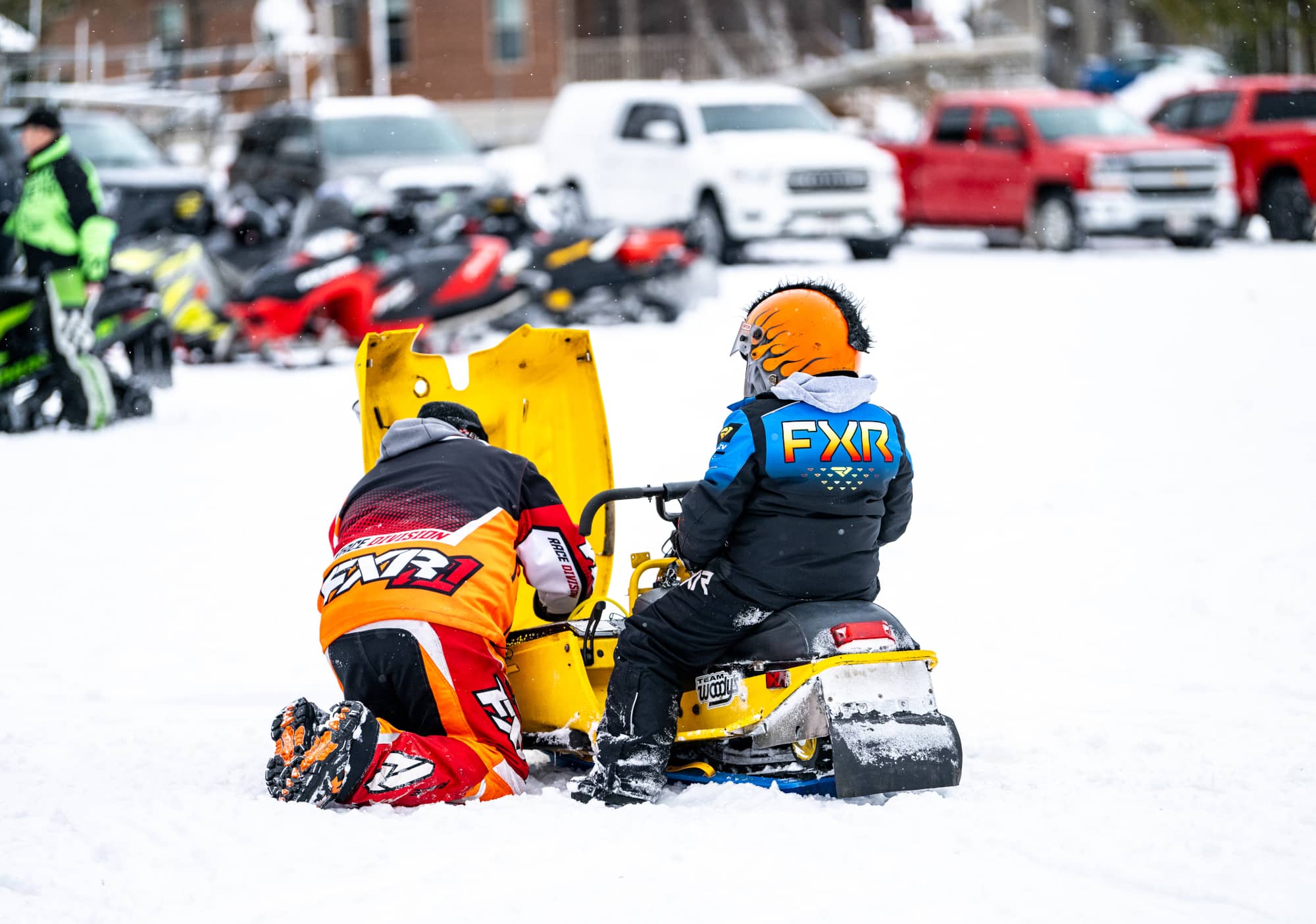 Man repairing snowmobile at Phelps Snowmobile Club Radar Run in Phelps in Vilas County Wisconsin
