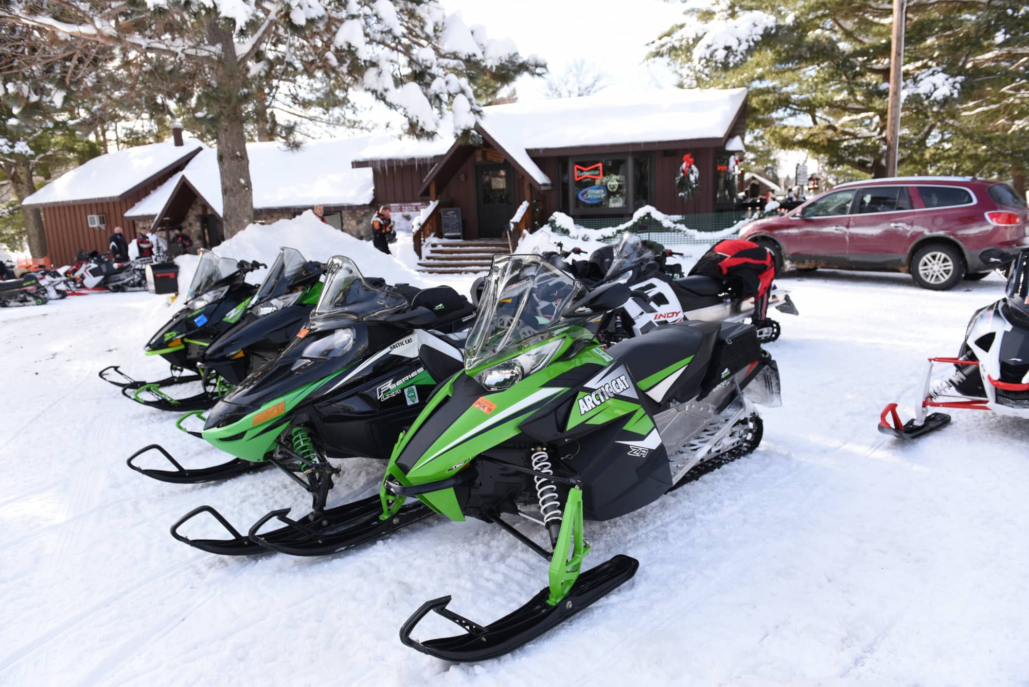 Snowmobiles parked outside Bauer’s Dam Resort in Conover Vilas County Wisconsin